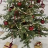 BronzeNutcracker2 Decorated Christmas tree featuring bronze nutcracker glass ornaments and red accents.