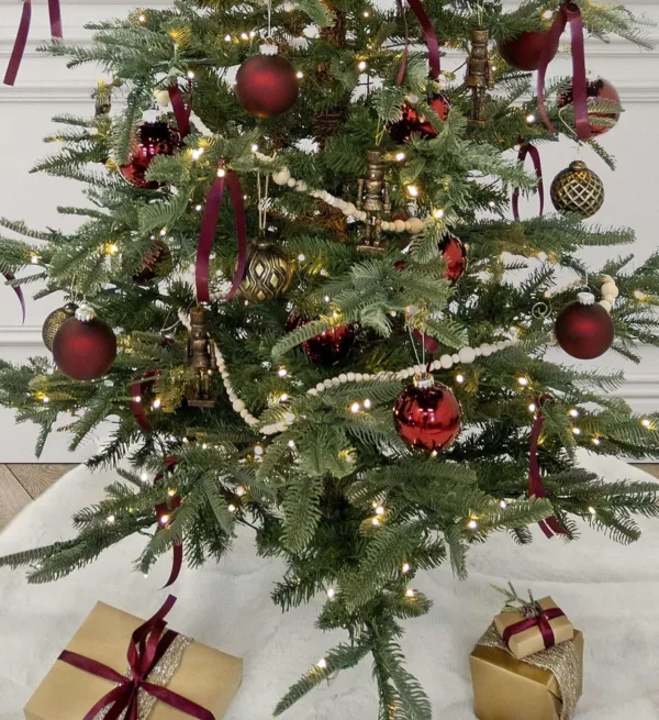 BronzeNutcracker2 Decorated Christmas tree featuring bronze nutcracker glass ornaments and red accents.