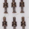 BronzeNutcrackerGlassOrnamentSet_6Pack Christmas Jungle Set of six bronze nutcracker glass Christmas ornaments with gold hanging loops.