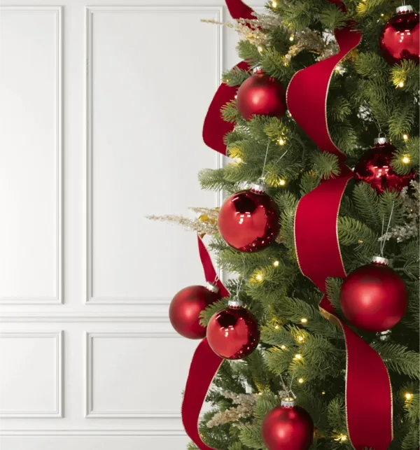 Classic Red Ribbon with gold edging draped through a Christmas tree paired with matching red bauble ornaments.