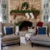 Cypress Spruce Garland styled across a rustic stone fireplace mantel with white stockings and gold accents.