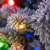 Close-up of frosted Queen Flock tree branches highlighting optional multi-color LED lights.