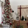 Tall King Flock Slim Artificial Christmas Tree styled with red baubles and plaid ribbon next to modern holiday decor.