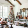 Queen Flock Full Artificial Christmas Tree styled with rust-colored velvet ribbon and metallic ornaments in a rustic living room.