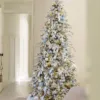 Queen Flock Slim Artificial Christmas Tree decorated with ice blue ribbon and silver ornaments in a hallway.