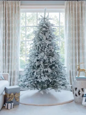 Unlit Queen Flock Full Artificial Christmas Tree featuring heavily frosted branches on a white tree skirt.