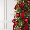 zoomed view of Red Essential Glass Ornaments on Artificial Christmas tree