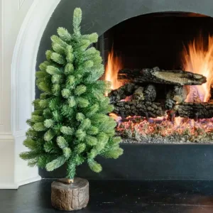 3' Royal Fir Artificial Christmas Tabletop Tree with realistic green needles in a faux wood log stand by a white fireplace hearth.