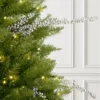 Silver Berry Picks styled horizontally on a pre-lit green Christmas tree.