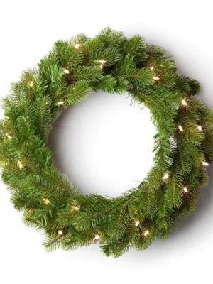Pre-lit King Douglas Fir Wreath with lush green foliage glowing with warm clear lights on a white background.