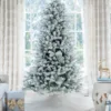 Unlit King Flock Full Artificial Christmas Tree with heavily flocked branches displayed in a bright studio setting.