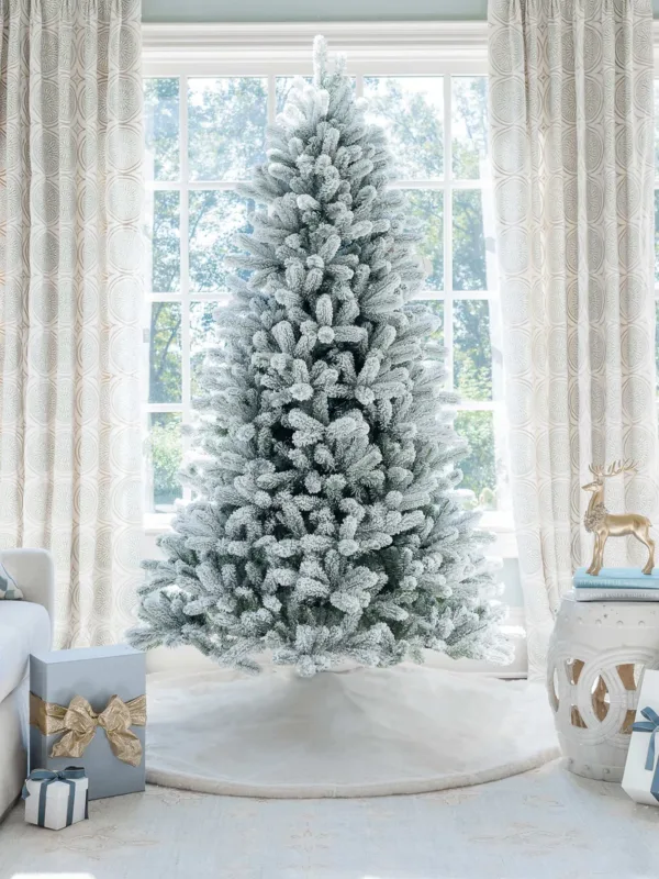 Unlit King Flock Full Artificial Christmas Tree with heavily flocked branches displayed in a bright studio setting.