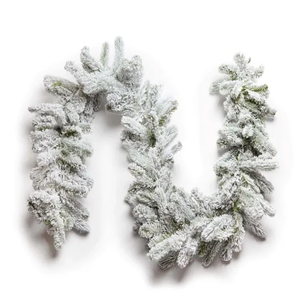 King Flock Garland laid flat in a curved wave pattern with heavy snow flocking on a plain white background.