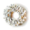 king-flock-led-wreath Pre-lit King Flock Wreath with heavily snow-flocked evergreen branches glowing with warm mini lights on a white background.