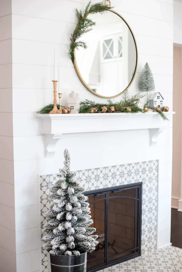 3' King Flock Artificial Christmas Tabletop Tree in a metal pot placed on a patterned hearth below a shiplap mantel.