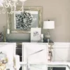 king flock wreath King Flock Wreath displayed on a large silver mirror above a mirrored dining room sideboard.