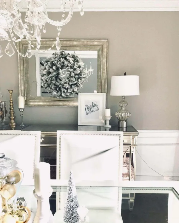 king flock wreath King Flock Wreath displayed on a large silver mirror above a mirrored dining room sideboard.