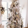 King Flock Full Artificial Christmas Tree lavishly styled with metallic rose gold ornaments and ribbon.