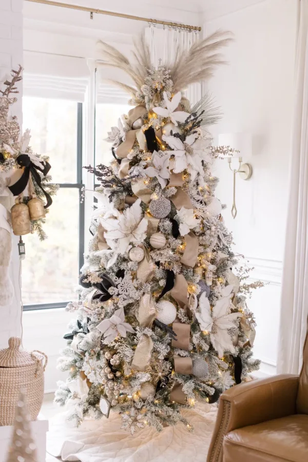 King Flock Full Artificial Christmas Tree lavishly styled with metallic rose gold ornaments and ribbon.